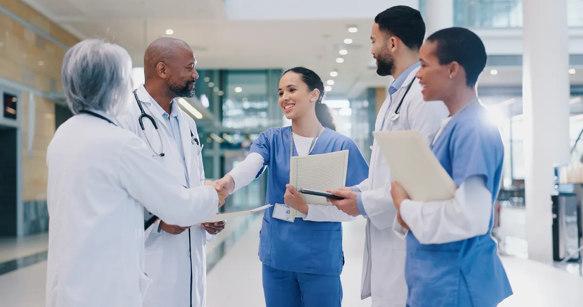 Doctor and nurse reviewing patient records in a hospital corridor